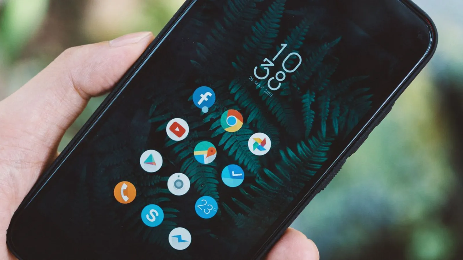 Phone held up showing its apps