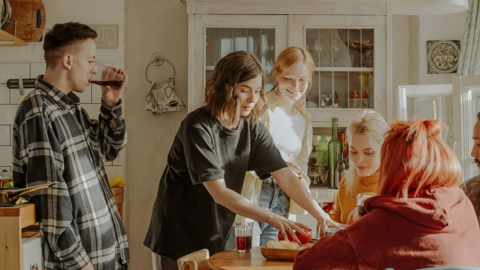 Housemates cooking together in a shared kitchen