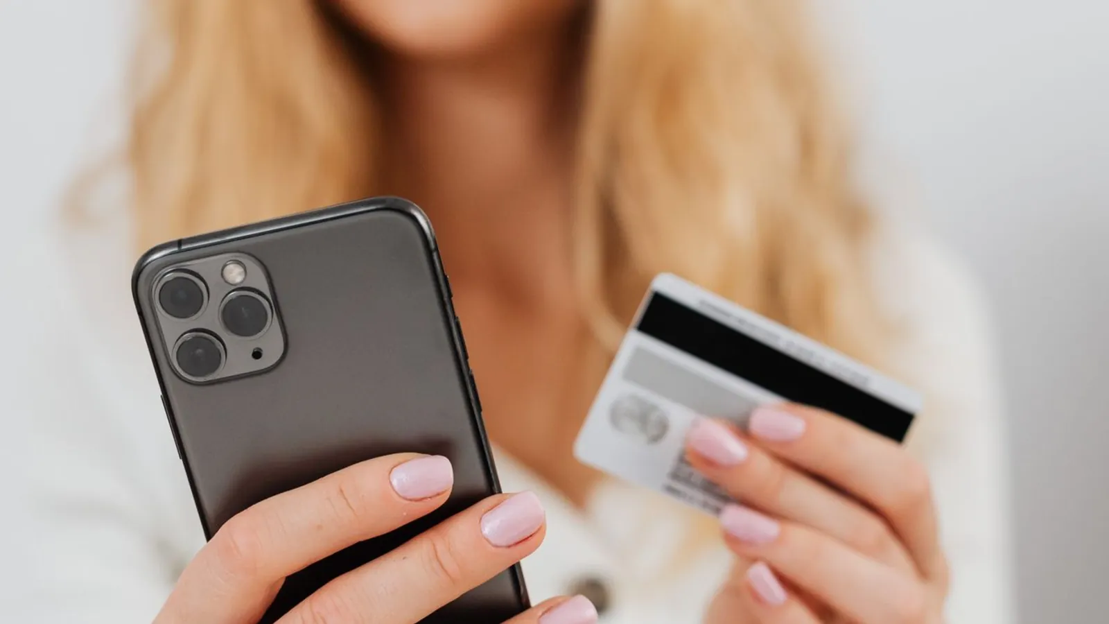Holding a phone and a bank card