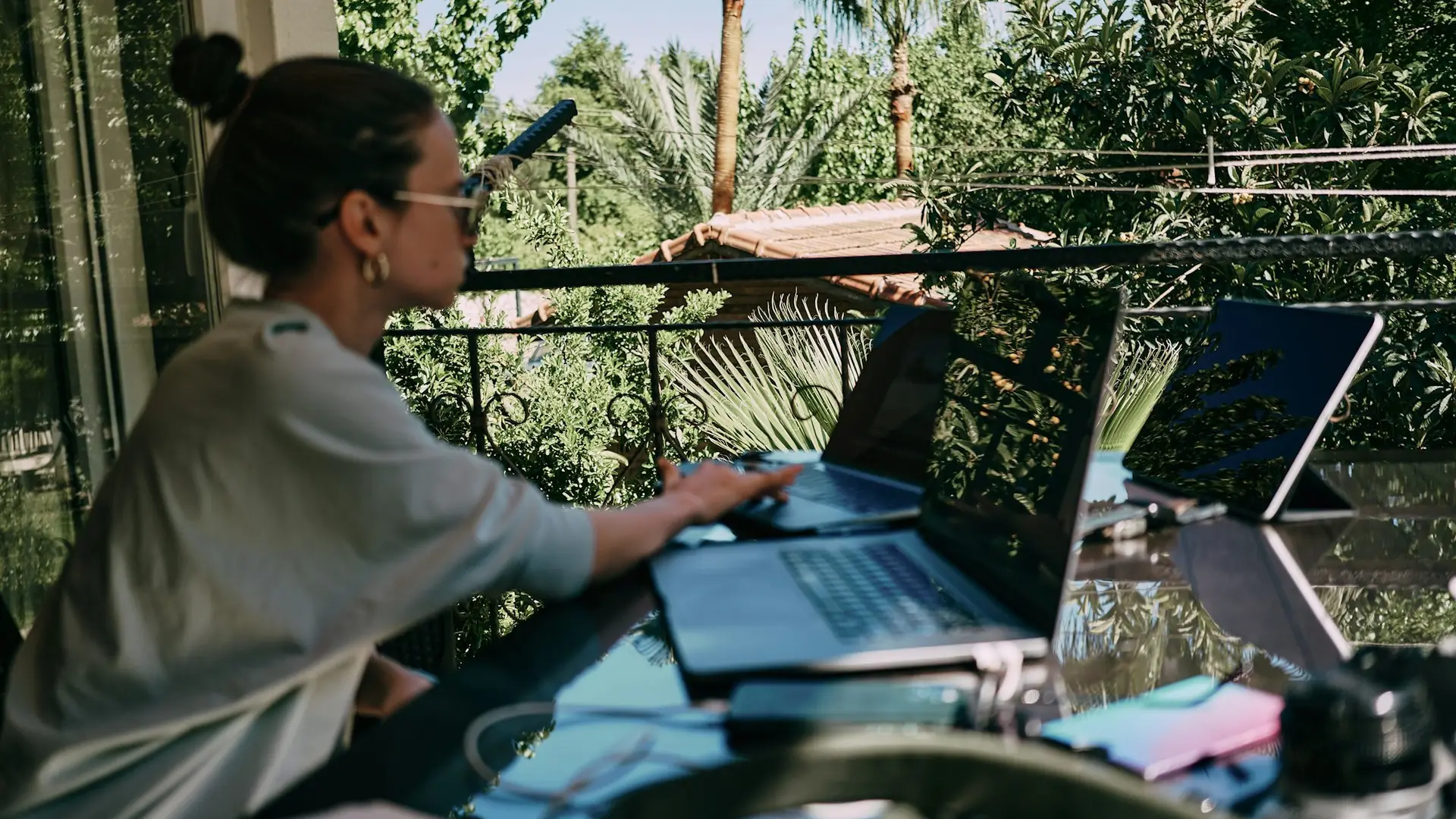 Digital nomad working from a tropical terrace